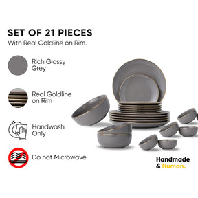 Set of 21 grey dinnerware pieces with gold rim on a white background, featuring text about material and care instructions.