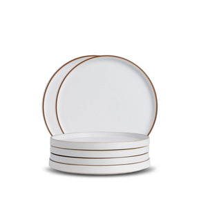 Set of white plates with gold rims on a white background