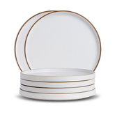 Set of white ceramic plates with gold rims on a white background