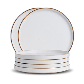 Set of white ceramic plates with gold rims on a white background