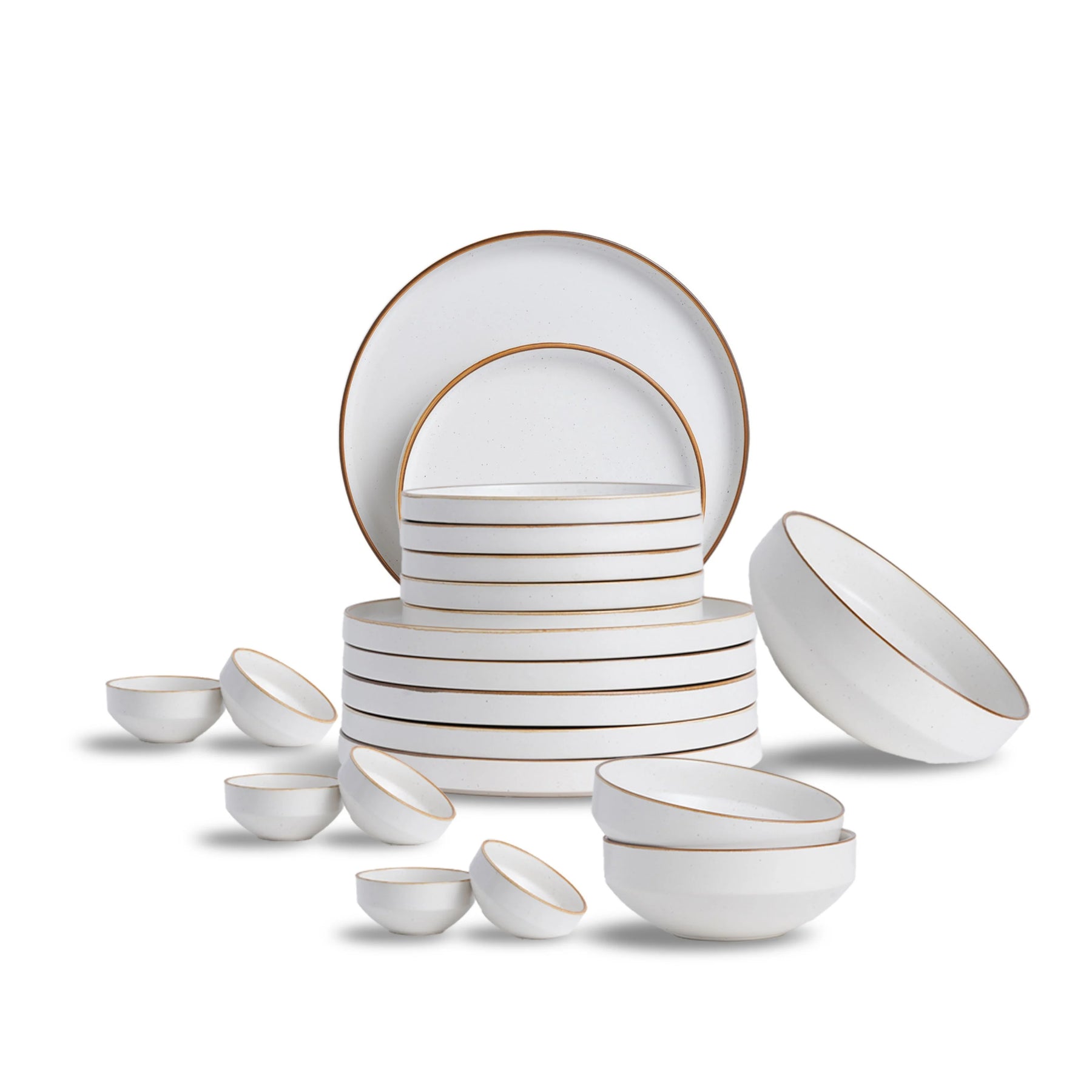 White ceramic dinnerware set with gold rims on a white background