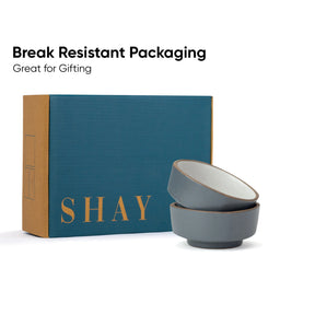 Two gray ceramic bowls stacked in front of a blue box with 'SHAY' branding on a white background.
