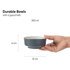 Gray bowl held in a hand with measurements on a white background