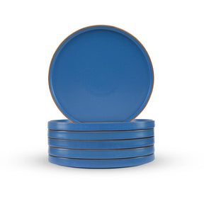 Set of blue plates with brown rim on a white background