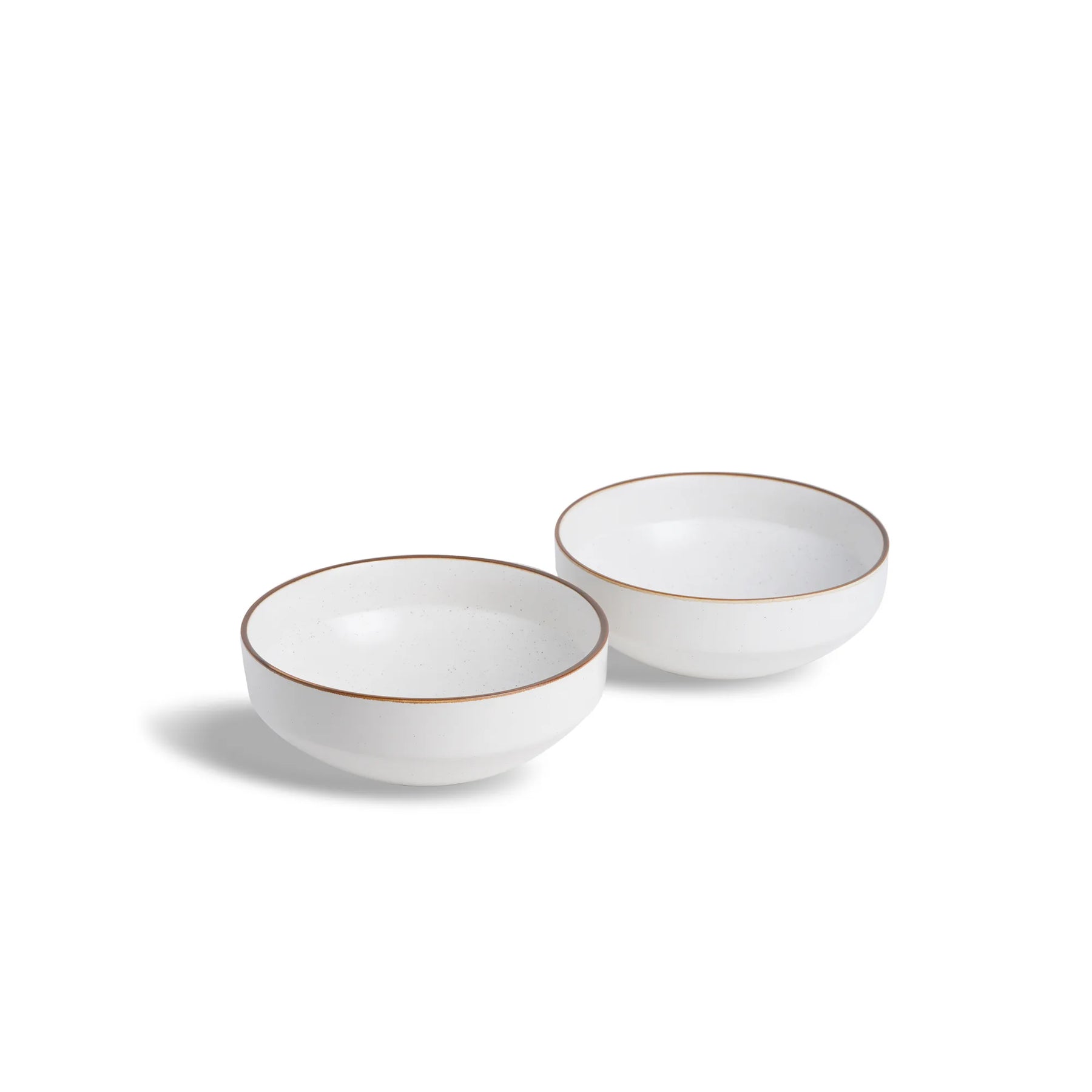 Two white ceramic bowls with gold rims on a white background