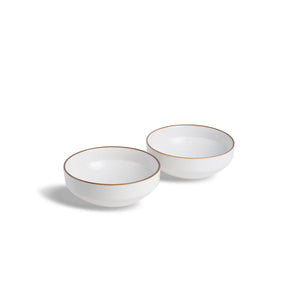 Two white ceramic bowls with gold rims on a white background