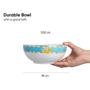 Hand holding a durable bowl with floral design, labeled 1100 ml and 18 cm, on a white background.