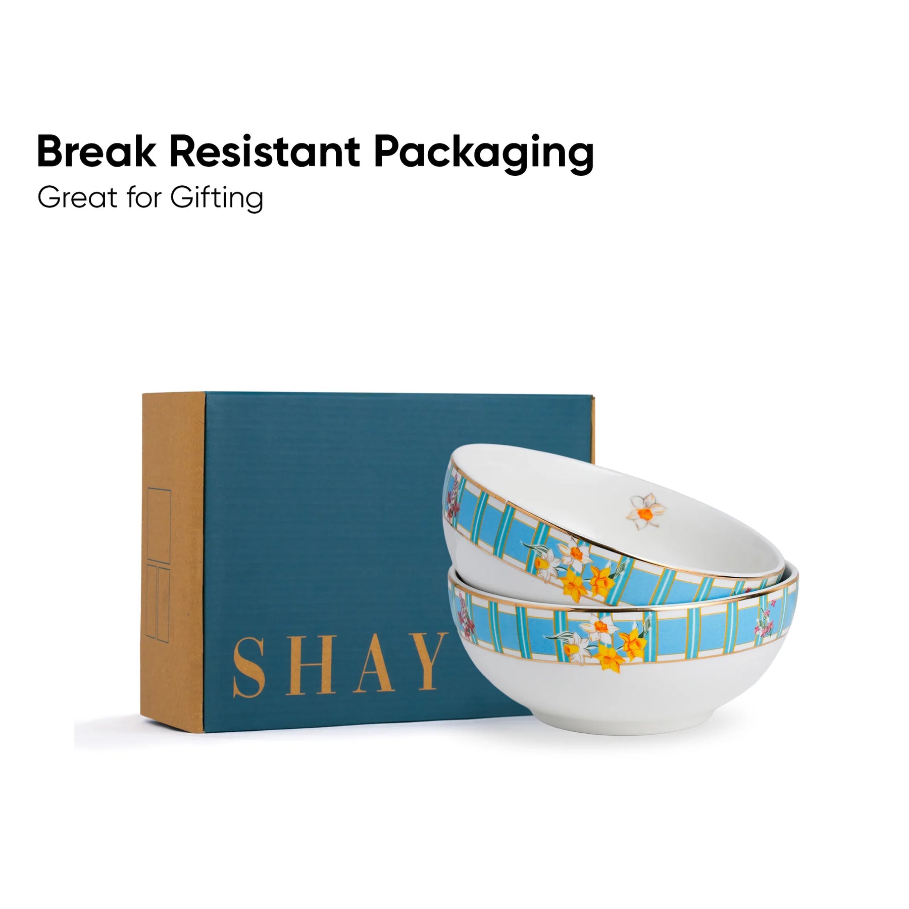 Two ceramic bowls with floral design on a 'SHAY' branded box, text 'Break Resistant Packaging Great for Gifting' above.