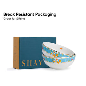 Two ceramic bowls with floral design on a 'SHAY' branded box, text 'Break Resistant Packaging Great for Gifting' above.