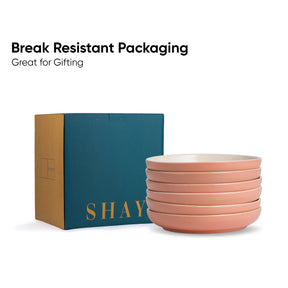 Stack of pink bowls with a teal box labeled 'SHAY' on a white background.