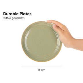 Hand holding a green plate with text about durable plates and a measurement of 18 cm.