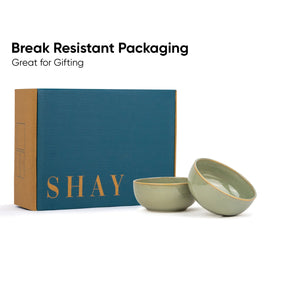 Two green ceramic bowls with 'SHAY' branding on a blue box against a white background.