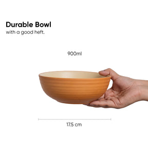Hand holding a durable bowl with measurements on a white background