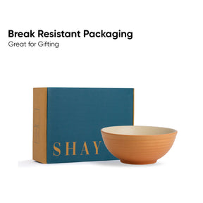Ceramic bowl next to a blue box with 'SHAY' branding on a white background