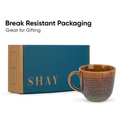 Ceramic mug with 'SHAY' branded box on a white background