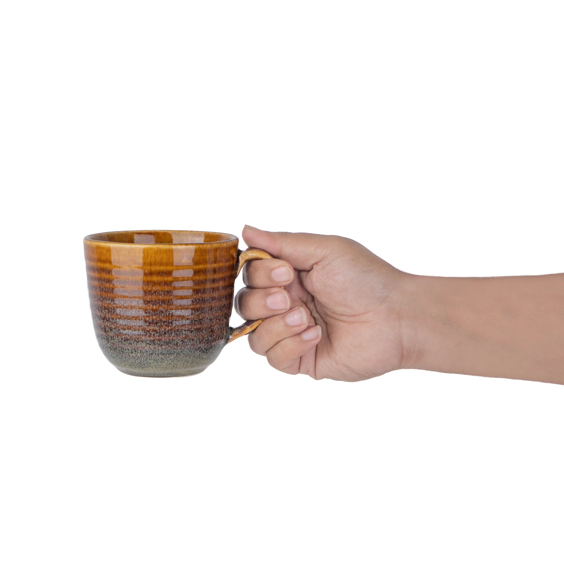 Hand holding a ceramic mug with a gradient design on a white background