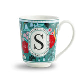 Decorative mug with floral design and letter 'S' on a white background