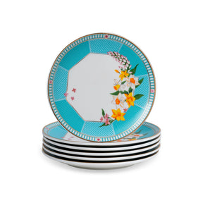 Set of four decorative plates with floral design on a white background