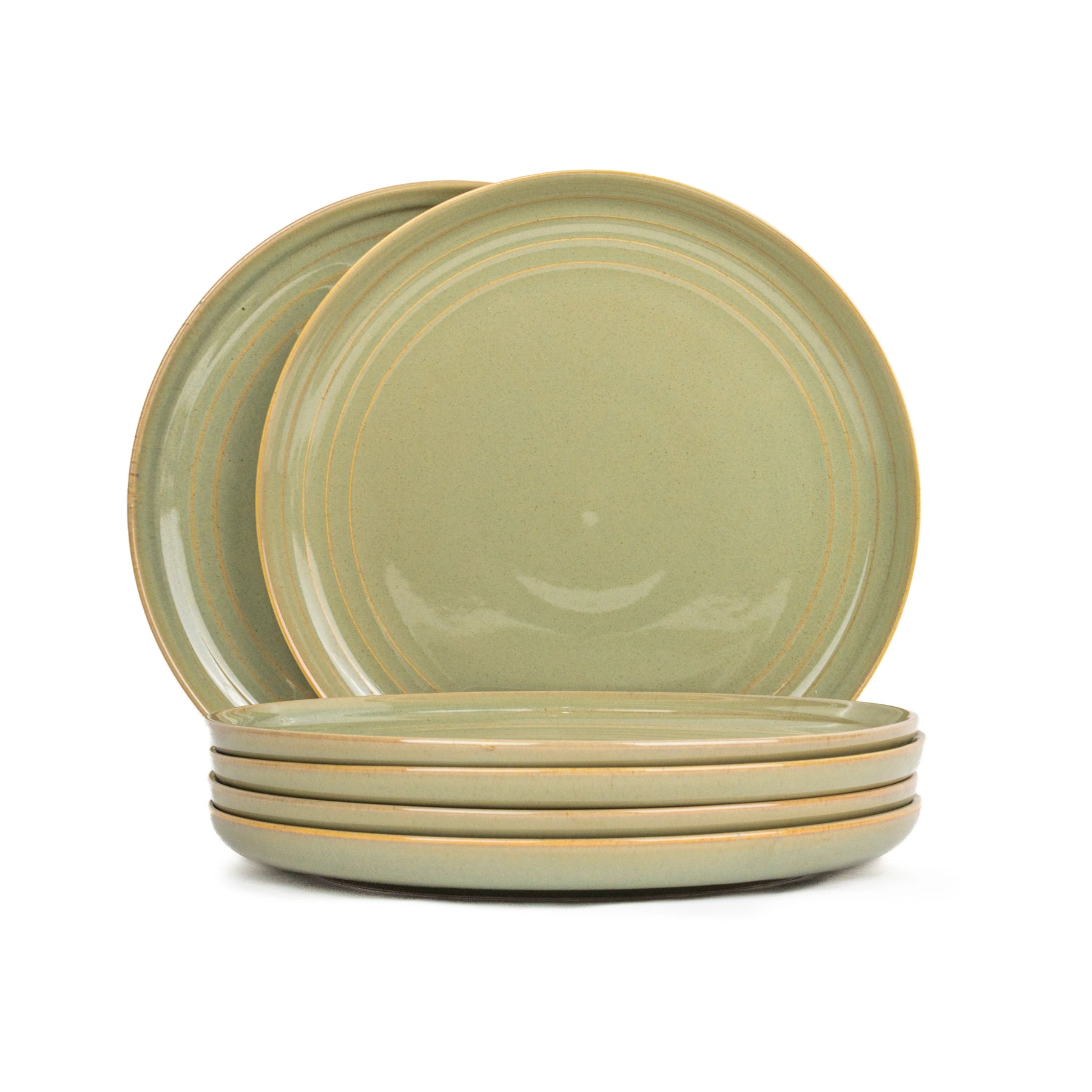 Set of four green ceramic plates on a white background