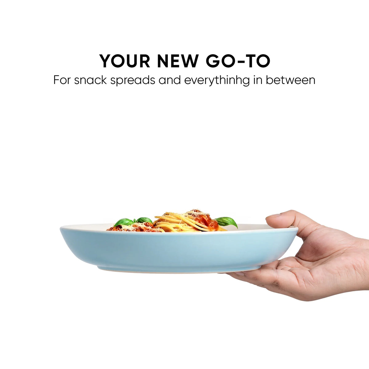 Hand holding a light blue bowl with pasta, text 'Your New Go-To' on a white background