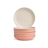 Set of four ceramic bowls in pink and beige on a white background