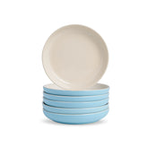 Set of four blue bowls with a beige bowl on top against a white background