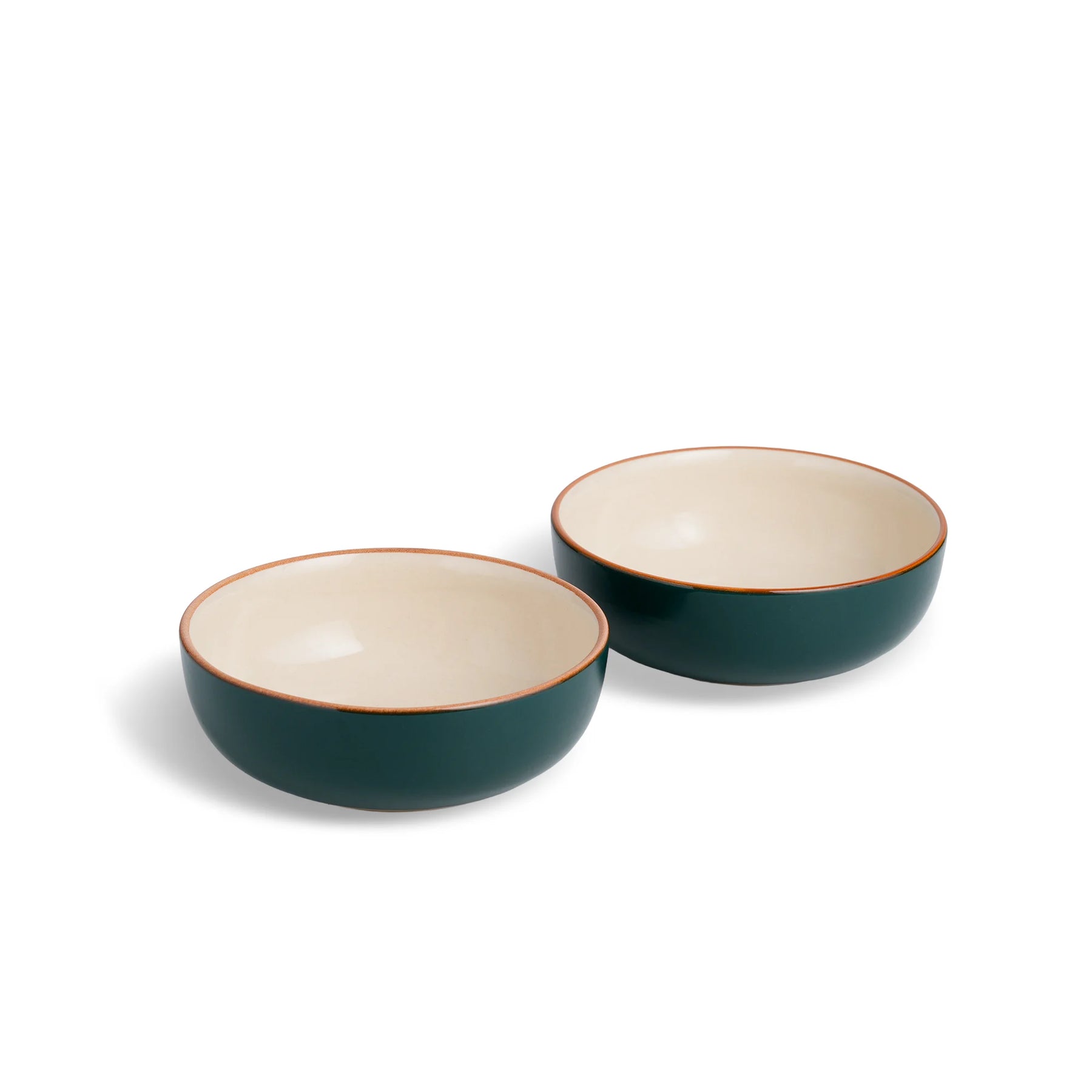 Two green ceramic bowls with beige interiors on a white background