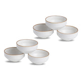 Set of six white ceramic bowls with gold rims on a white background