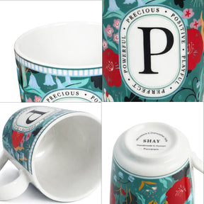 Decorative mug with floral design and text on a white background