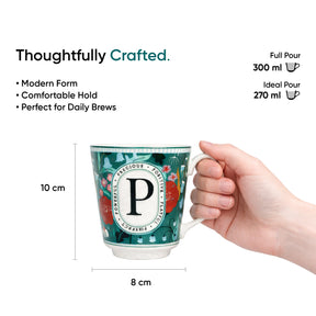 Mug with floral design and letter 'P', held by a hand, with measurements and text on a white background.