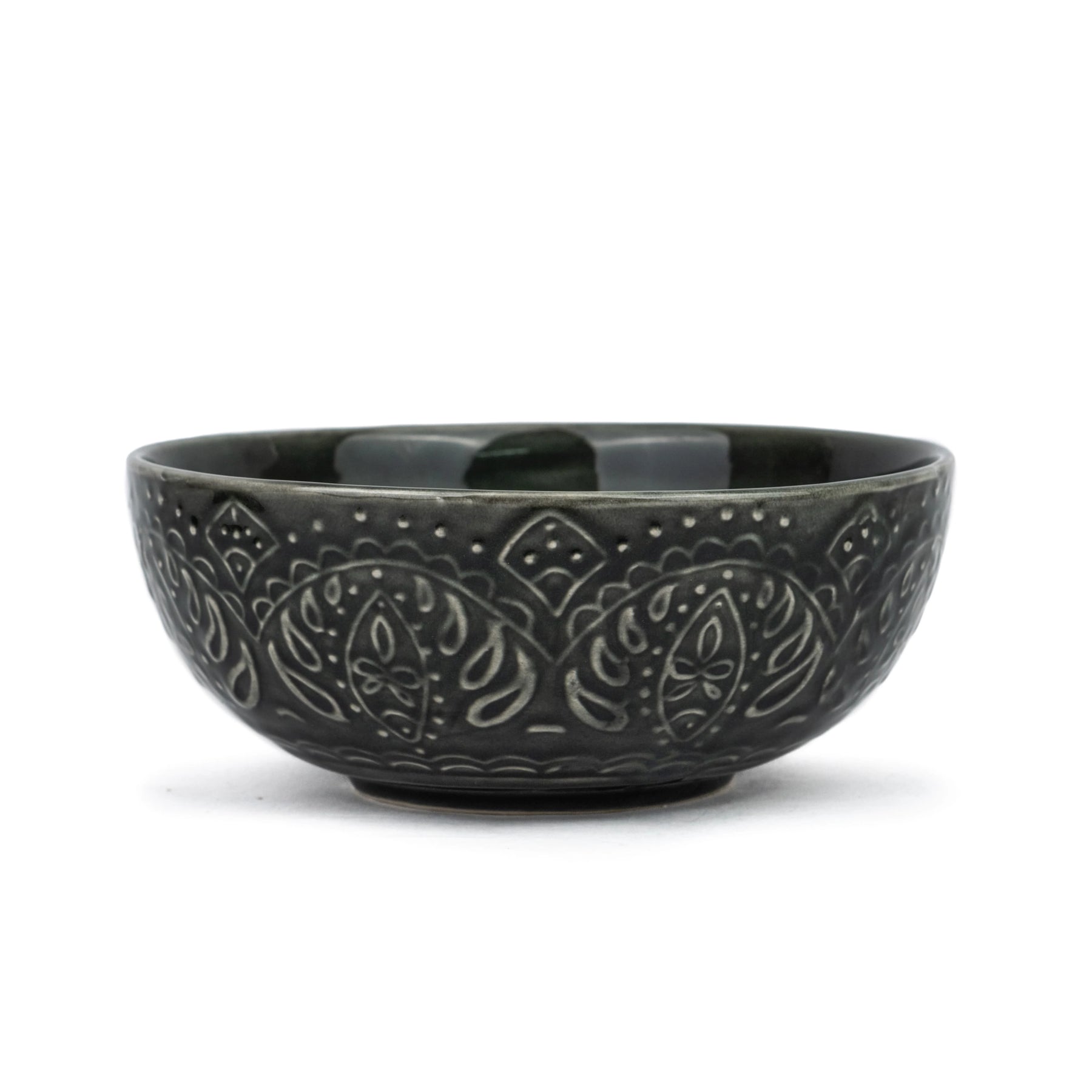 Black ceramic bowl with embossed patterns on a white background