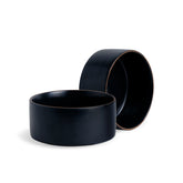 Two black ceramic bowls on a white background