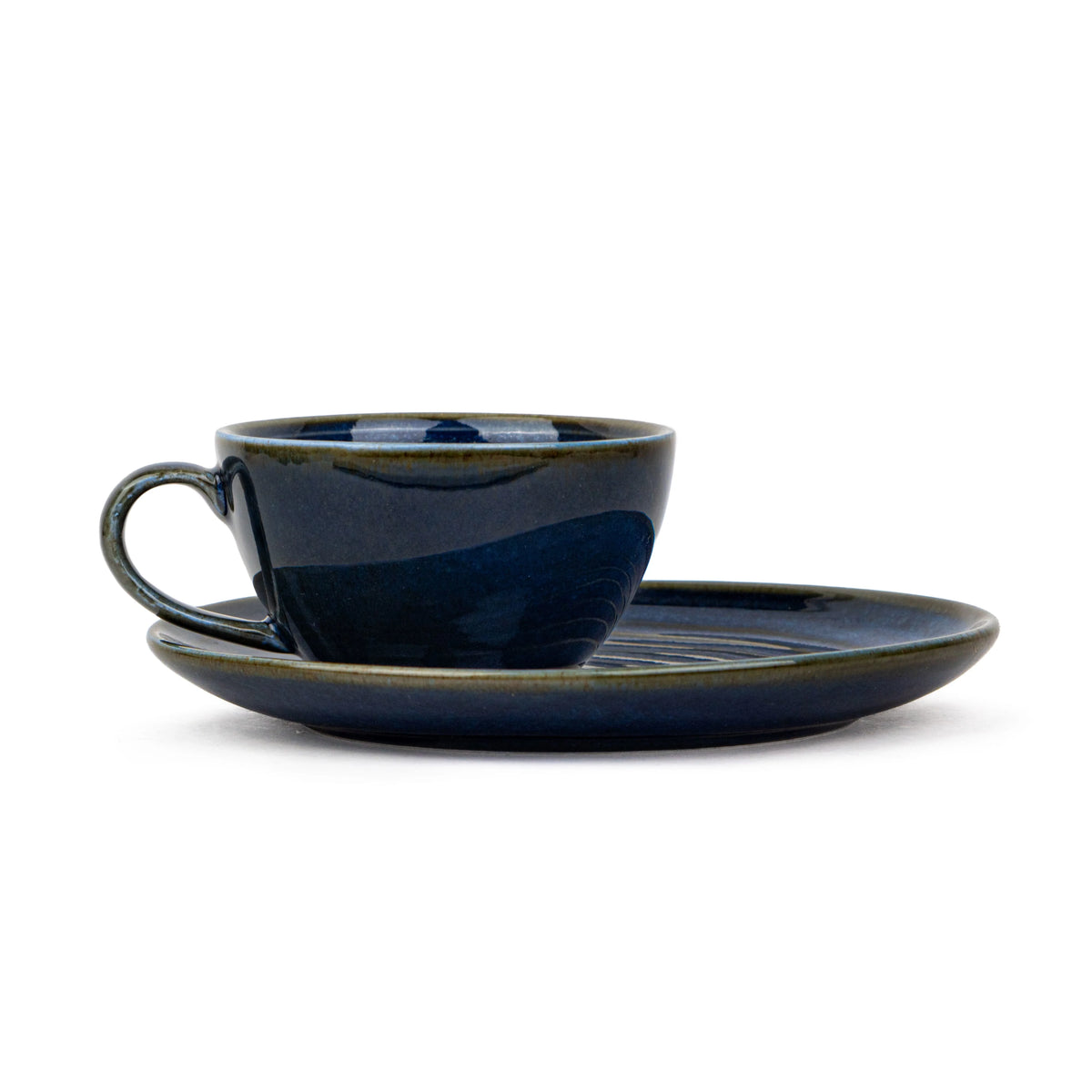 Navy blue ceramic cup and saucer set on a white background