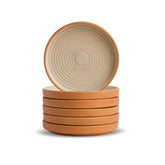 Stack of ceramic bowls with a beige interior and brown exterior on a white background