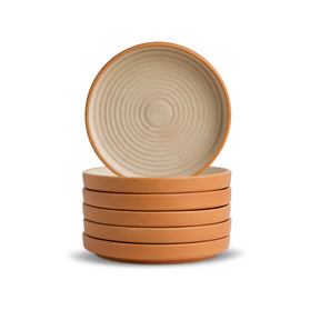 Stack of ceramic bowls with a beige interior and brown exterior on a white background