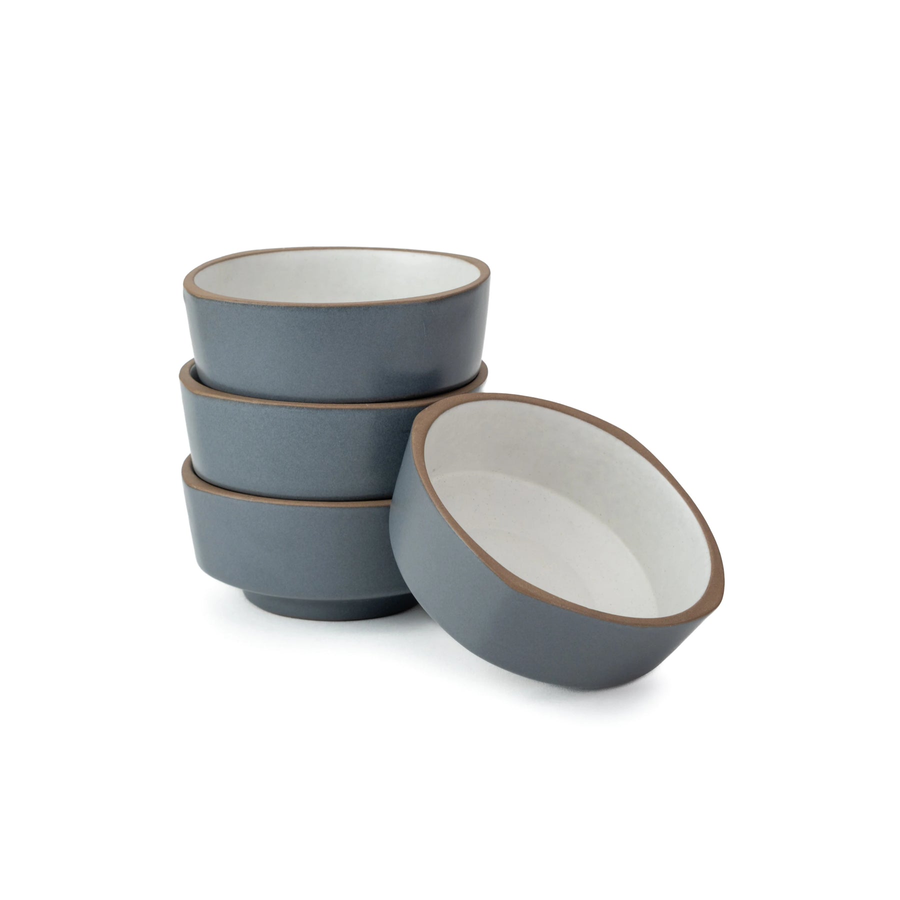 Set of four blue ceramic bowls on a white background