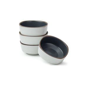Set of four ceramic bowls with gray interior and white exterior on a white background